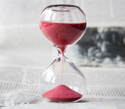 picture of hourglass with sand, half full.